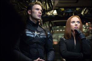 Chris Evans as Captain America, left, and Scarlett Johansson as Black Widow in a scene from 