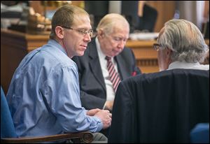 Former Foxx Liquor Store clerk Nicholas Thompson, left, speaks with attorneys Andy Douglas and Rick Kerger, right.  He is charged with selling or furnishing intoxicating liquor to a minor.
