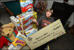 Mary Lu Marr, of Dublin, Calif., shows off just a few of the items she has won playing hundreds of sweepstakes a day online at her home. An estimated 55 million Americans enter sweepstakes each year.