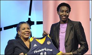 Florida States Natasha Howard holds up  an Indiana Fever jersey.