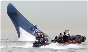 South Korean coast guard officers try to rescue passengers from the sinking ferry. 