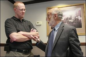 Tim Bork, left, speaks with his attorney Alan Konop, right, in the foyer of the Fulton County Court Eastern District, on September 11, 2013.  Mr. Konop is representing  Mr. Bork in court over charges stemming from his refusal to register his dog 