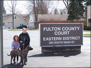 This photo was taken after the court dismissed the case today, April 16, 2014. The boy is Tyler Bork, 11, and the girl is Kayla Bork, 6. The dog is Bailey, and she is about 2 now. Their father, Tim Bork, had been in court over charges stemming from his refusal to register his dog 