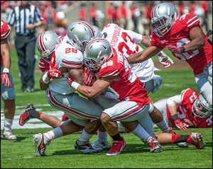 Jayme Thompson makes a tackle in Ohio State’s spring game. He is transferring after sitting out last season because of an injury.