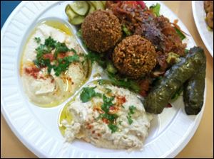 The Lazeez plate includes two pieces of falafal, two veggie grape leaves, hummus, baba gannouch, pita bread and a side of soup or salad.
