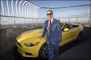 Bill Ford, Ford Motor Company's executive chairman, stands with the all-new 2015 Mustang convertible as it's introduced today on the 86th floor observation deck of the Empire State Building during the New York International Auto Show.