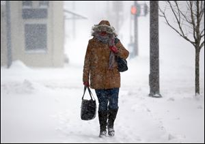 LaVera Scott walks along Jackson Street toward One Government Center during a snowstorm Feb. 5.   Thankfully, the worst of winter is behind us.