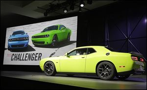 The 2015 Dodge Challenger is introduced Thursday at the New York International Auto Show. With gas prices at an average of $3.45 this year, muscle cars are back in focus at the auto show.
