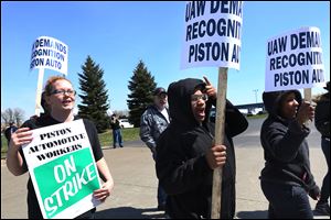 Piston Automotive employees, from left, Amanda Dickerson, Rae-Lyn Fobbs, and Sonya Hill picket in support of forming a union in North Toledo. About 50 employees, other union members, and supporters turned out to picket Thursday. The dispute ended about eight hours after it started.