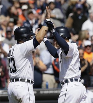 Detroit’s Ian Kinsler, right, is congratulated by Alex Avila after Kinsler's three-run home run in the fifth inning gave the Tigers a 4-3 lead over the Indians. Joe Nathan finished off the game with a save.
