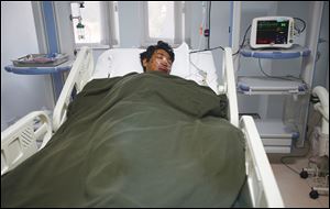 A Nepalese Sherpa, Dawa Tashi, who was injured during the avalanche, gets treat-ment at a hospital in Kathmandu, Nepal. The avalanche swept down Mount Everest early Friday, killing at least 12 Nepalese guides. Four people are missing.