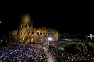 Faithful attend the Via Crucis (Way of the Cross) torchlight procession to be celebrated by Pope Francis in front of the Colosseum on Good Friday in Rome.