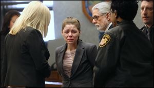 Amanda Bacon, center, cries as she is led away after a jury found her guilty on charges of murder and child endangerment on today at the Lucas County Courthouse in downtown Toledo.