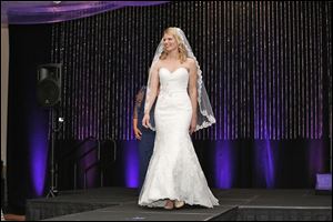 Teresa Hillis models a wedding gown during the 7th annual Luncheon & Fashion Show 