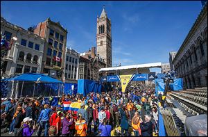 Runners and race fans crowd Boylston Street at the  finish line on Sunday. Officials gave out extra bibs after those affected by last year’s bombing stated their need to run the course today.