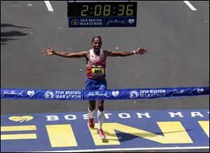 Meb Keflezighi, of San Diego, Calif., celebrates as he crosses the finish line to win the 118th Boston Marathon today in Boston.