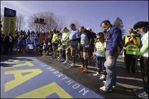 Mobility-impaired runners gather at the start line for a moment of silence before the race.