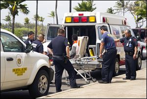 A 16-year-old boy, seen sitting on a stretcher center, who stowed away in the wheel well of a flight from San Jose, Calif., to Maui is loaded into an ambulance at Kahului Airport in Kahului, Maui, Hawaii  Sunday.