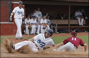Lake's Todd Walters escapes a tag at home by Rossford’s Noah Asmus after the ball was dropped.