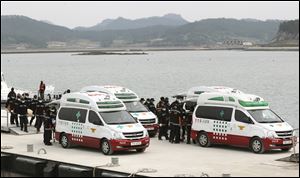 Emergency workers carry the bodies of passengers aboard the Sewol ferry.