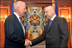 U.S. Vice President Joe Biden, left, is greeted by Oleksandr Turchynov, the acting Ukrainian prime minister and president, today in Kiev.