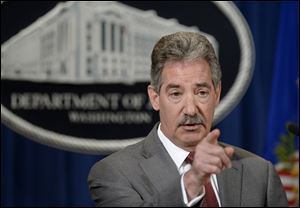 Deputy Attorney General James Cole gestures during a news conference at the Justice Department.