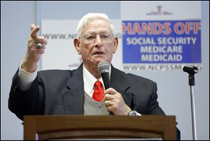 Sam Burnett, a volunteer with the National Committee to Preserve Social Security and Medicare, speaks during Wednesday’s event at the Margaret Hunt Senior Center in South Toledo.