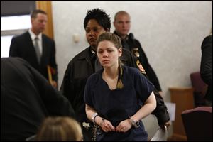 Amanda Bacon is lead out of the courtroom after sentencing by Judge Frederick McDonald.