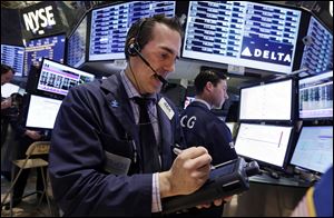 Trader Gregory Rowe works on the floor of the New York Stock Exchange today.