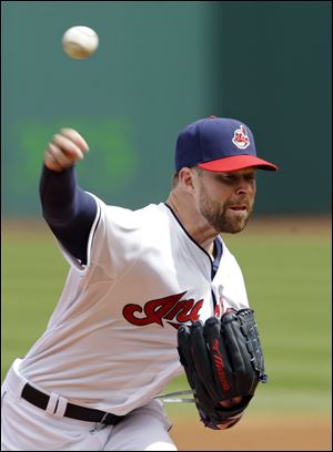 Cleveland Indians starting pitcher Corey Kluber delivers against the Kansas City Royals in the first inning today in Cleveland.