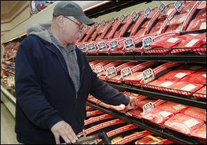 Rob Palicki, of Perrysburg, buying beef at Walt Churchill's in Perrysburg. Store employees at Walt Churchill's Market in Perrysburg prepare meat for sale at the store in Perrysburg.