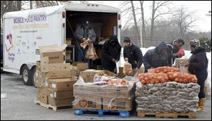 Local companies are supporting Food for Thought, an organization that distributes food to people in need, shown here at Holy Trinity Lutheran Church in Toledo on Feb. 9, 2011. 