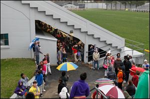 Waite High School students gather under the seats of their school's  Mollenkopf Stadium  in response to an alleged bomb threat against the school early today.