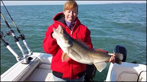 Krissy Fox of Gibsonburg with a 31-inch, 12.3 pound walleye she caught near the Lake Erie islands on Easter Sunday on her first walleye fishing trip.