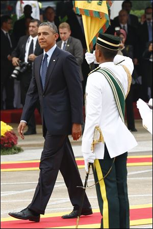 U.S. President Barack Obama walks after a welcome ceremony today at Parliament Square in Kuala Lumpur, Malaysia.