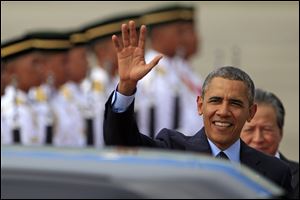 U.S. President Barack Obama waves upon his arrival for his three-day visit in Malaysia today at the Royal Malaysian Air Force base in Subang