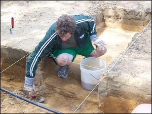 Josh Lieto, a former archaeology student of Professor Ken Mohney and a current volunteer, working on a dig in Temperance last summer. Professor Mohney teaches archaeology at Monroe County Community College and will speak May 5 at the Bedford Branch Library.