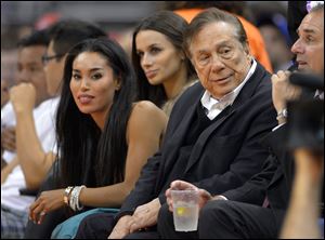 Los Angeles Clippers owner Donald Sterling, right, and V. Stiviano, left, watch the Clippers play in October.