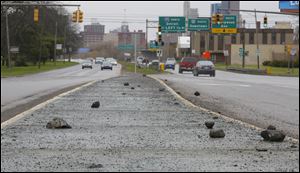 Pieces of concrete on the median in between the north and south bound lanes on the Anthony Wayne Trail heading toward downtown.