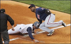 Toledo’s Ezequiel Carrera is tagged out by Gwinnett’s Edward Salcedo while trying to steal third base during the first inning at Fifth Third Field. Rain delayed Tuesday’s game for 53 minutes.