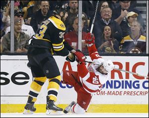 Boston Bruins' Zdeno Chara (33) checks Detroit Red Wings' Henrik Zetterberg (40) during the second period in Game 5.