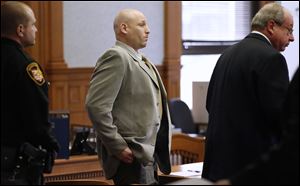 David Zielinski, with attorney Mark Geudtner, right, stands during a break in his trial today in Lucas County Common Pleas Court in Toledo.