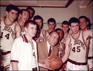 This undated photo provided by Saint Joseph's University shows the school's basketball coach Jack Ramsay, center, when his team won his 200th career game. Ramsay, a Hall of Fame coach who led the Portland Trail Blazers to the 1977 NBA championship before he became one of the league's most respected broadcasters, has died following a long battle with cancer. He was 89.