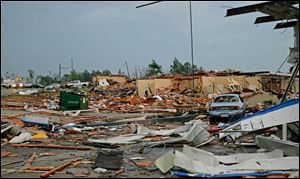 A damage building is seen in Tupelo, Miss. Monday. Tornados flattened homes and businesses, flipped trucks over on highways and injured numerous people in Mississippi and Alabama on Monday as a massive, dangerous storm system passed over several states in the South.
