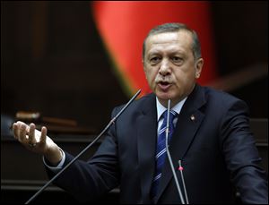 Turkish Prime Minister Recep Tayyip Erdogan addresses his supporters at the parliament in Ankara, Turkey, today.