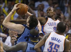 Memphis Grizzlies center Marc Gasol, back left, shoots as Oklahoma City Thunder forward Serge Ibaka (9) defends during the fourth quarter. Ibaka's game-winning put-back was waived off after officials determined it came after the buzzer.