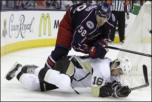 Columbus Blue Jackets' David Savard, top, knocks Pittsburgh Penguins' Brandon Sutter to the ice during the first period of Game 6 of a first-round NHL playoff hockey series Monday, April 28, 2014, in Columbus, Ohio.