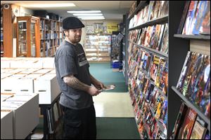 Josh Emmerich, of West Toledo, browses the comic selection at Game Room Comics.