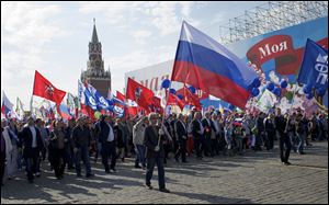 Members of Russian Trade Unions march during the May Day celebration in Red Square, Moscow, Russia. About 100,000 people have marched through Red Square to celebrate May Day, the first time the annual parade has been held on the vast cobblestoned square outside the Kremlin since the fall of the Soviet Union in 1991.
