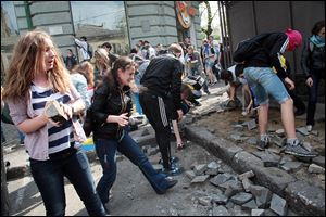 Ukrainian government supporters dig for stones during a clash Friday with pro-Russians in the Black Sea port of Odessa. The city had remained largely untroubled by unrest since the February toppling of President Viktor Yanukovych.